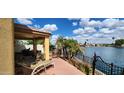 Back patio area with patio table and lounge chair overlooking waterfront views at 8935 W Acoma Dr, Peoria, AZ 85381