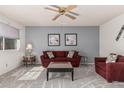 Inviting living room with neutral walls, plush carpet, and comfortable seating arrangement at 9816 N 95Th Dr # A, Peoria, AZ 85345