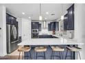 Modern kitchen boasts stainless steel appliances, a center island with breakfast bar, and ample counter space at 10425 E Corbin Ave, Mesa, AZ 85212