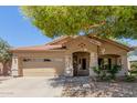 Inviting home exterior featuring a well-maintained front yard and a two-car garage at 1072 E Jade Dr, Chandler, AZ 85286