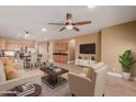Spacious living room with a ceiling fan, lovely furniture, and an open floor plan to the kitchen at 1072 E Jade Dr, Chandler, AZ 85286