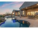 Beautiful backyard featuring a private pool, outdoor seating, and a covered patio for relaxing evenings at 10799 E Florence Way, Scottsdale, AZ 85262
