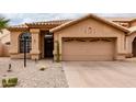 Charming single-story home featuring desert landscaping and a two-car garage at 11163 E Laurel Ln, Scottsdale, AZ 85259