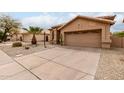 Single-story home featuring desert landscaping, driveway, and a two-car garage at 11163 E Laurel Ln, Scottsdale, AZ 85259