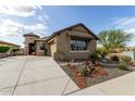 Inviting single-story home featuring desert landscaping, private drive and attractive architecture at 11571 E Chevelon Trl, Gold Canyon, AZ 85118