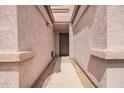The entryway features a walkway between two walls that are the same color as the garage at 125 S 56Th St # 100, Mesa, AZ 85206