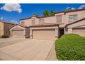 Desirable townhome showcases a tile roof, neutral stucco, private garage, and manicured shrubs at 125 S 56Th St # 100, Mesa, AZ 85206