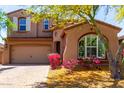 Charming two-story home featuring a well-manicured front yard and a two car garage at 13749 W Amberwing St, Peoria, AZ 85383