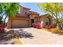 Charming two-story home featuring a well-manicured front yard and a two car garage at 13749 W Amberwing St, Peoria, AZ 85383