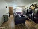 Cozy living room features hardwood floors, comfortable seating, and natural light, creating an inviting atmosphere at 141 N Date -- # 7, Mesa, AZ 85201