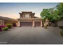 Charming two-story home featuring a three-car garage, desert landscaping, and a well-maintained front yard at 16228 W Crocus Dr, Surprise, AZ 85379