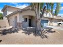 Beautiful two-story home featuring a covered porch and a well-maintained front yard with mature trees at 17812 N Carmen Ave, Maricopa, AZ 85139