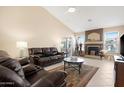 Inviting living room showcasing a fireplace, tiled floors, a ceiling fan, and plush seating at 18163 W Addie Ln, Surprise, AZ 85374