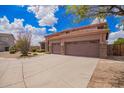 Spacious three-car garage with desert landscaping and mature trees at 2146 S Drexel --, Mesa, AZ 85209