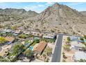 Stunning aerial view of the community nestled against picturesque desert mountains with swimming pools and lush greenery at 2315 E Cholla St, Phoenix, AZ 85028