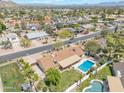 Expansive aerial shot showcasing neighborhood homes with pools, solar panels, and well-manicured lawns at 2315 E Cholla St, Phoenix, AZ 85028