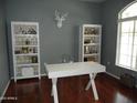 Clean and organized office with white desk, chair, and shelving at 2401 E Rio Salado Pkwy # 1225, Tempe, AZ 85288