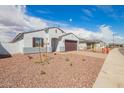 Charming single-story home with paver driveway, rock landscaping and view of neighborhood street at 24356 W La Salle St, Buckeye, AZ 85326
