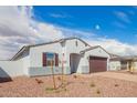 Beautiful single-story home with a two-car garage and easy-care rock landscaping at 24356 W La Salle St, Buckeye, AZ 85326