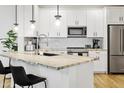 Modern kitchen features white cabinetry, stainless steel appliances, and a stylish backsplash at 2511 W Queen Creek Rd # 165, Chandler, AZ 85248