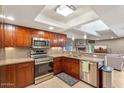 Well-appointed kitchen features stainless steel appliances, modern lighting, and an open layout to the adjacent living space at 33 W Missouri Ave # 17, Phoenix, AZ 85013