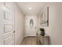 Welcoming entryway with a decorative door and modern console table with plant accent at 3502 W Gardenia Ave, Phoenix, AZ 85051