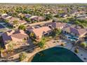 Gorgeous aerial view of the property with landscaping, lake, and community at 3750 E Sawtooth Dr, Chandler, AZ 85249