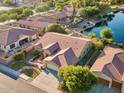 Expansive aerial shot showcases the home's private yard, serene lake, and a beautiful neighborhood at 3750 E Sawtooth Dr, Chandler, AZ 85249
