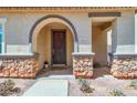 Inviting front door with stone accents, covered entryway and address number at 3841 E Jasper Dr, Gilbert, AZ 85296