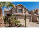 Charming two-story home featuring a desert landscape, two car garage and a terracotta tile roof at 4128 E Coolbrook Ave, Phoenix, AZ 85032