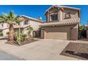 Charming two-story home featuring a desert landscape, two car garage and a terracotta tile roof at 4128 E Coolbrook Ave, Phoenix, AZ 85032