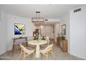 Bright dining area featuring modern lighting and adjacent breakfast bar to the kitchen at 5350 E Deer Valley Dr # 2435, Phoenix, AZ 85054