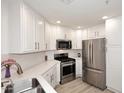 Clean kitchen featuring stainless steel appliances, white cabinetry, and light countertops at 5350 E Deer Valley Dr # 2435, Phoenix, AZ 85054