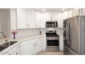 Stylish kitchen features stainless steel appliances, white cabinetry, and light countertops at 5350 E Deer Valley Dr # 2435, Phoenix, AZ 85054