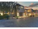 Beautiful desert home exterior showcasing a private drive and well-kept landscaping at sunset at 5527 E Arroyo Verde Dr, Paradise Valley, AZ 85253