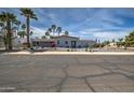 Inviting single-story home with desert landscaping, palm trees, and a well-maintained facade at 6801 E Sheena Dr, Scottsdale, AZ 85254