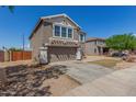 Two-story house showcasing a two-car garage, a long driveway, and a manicured lawn at 7230 N 70Th Ln, Glendale, AZ 85303