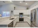 Modern kitchen featuring white cabinetry, stainless steel appliances, and sleek countertops at 737 W Desert Valley Dr, San Tan Valley, AZ 85143