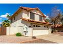 Charming two-story home featuring a tile roof, two-car garage, and desert landscaping at 7402 W Kerry Way, Glendale, AZ 85308