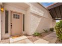 Inviting front door with a 'hello' mat, showcasing the home's warm welcome and curb appeal at 7467 E Pleasant Run, Scottsdale, AZ 85258