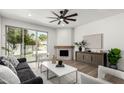 Elegant living room with fireplace, sleek furniture, and sliding doors to outdoor space at 7467 E Pleasant Run, Scottsdale, AZ 85258