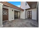 Tiled front courtyard with a decorative front door and large sliding glass windows at 7826 N 21St Ln, Phoenix, AZ 85021