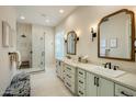 Modern bathroom with dual vanities, stylish mirrors, and glass-enclosed shower at 7979 E Princess Dr # 26, Scottsdale, AZ 85255