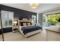 Comfortable main bedroom with elegant wall paneling and private access to the outdoor living area at 7979 E Princess Dr # 26, Scottsdale, AZ 85255