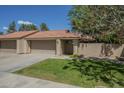 Charming home featuring a terra cotta roof, a two-car garage, and a well-maintained front lawn at 945 N Pasadena -- # 84, Mesa, AZ 85201