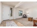 Bright and airy living room with neutral colors, tile flooring and a cozy armchair by the window at 1322 W Spur Dr, Phoenix, AZ 85085