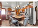 Spacious kitchen featuring wood cabinets, a granite island, and stainless steel appliances at 2017 E Willis Rd, Gilbert, AZ 85297