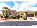 Charming single-story home with a tile roof, desert landscaping, and an attached two car garage at 23128 N Sol Mar Ct, Sun City West, AZ 85375