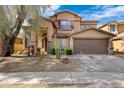 Inviting two-story home with a well-maintained desert landscape and a two car garage at 2408 W Crimson Ter, Phoenix, AZ 85085