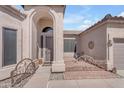 Charming home entry with an arched doorway, custom iron accents, and desert landscaping at 3060 N Ridgecrest -- # 200, Mesa, AZ 85207